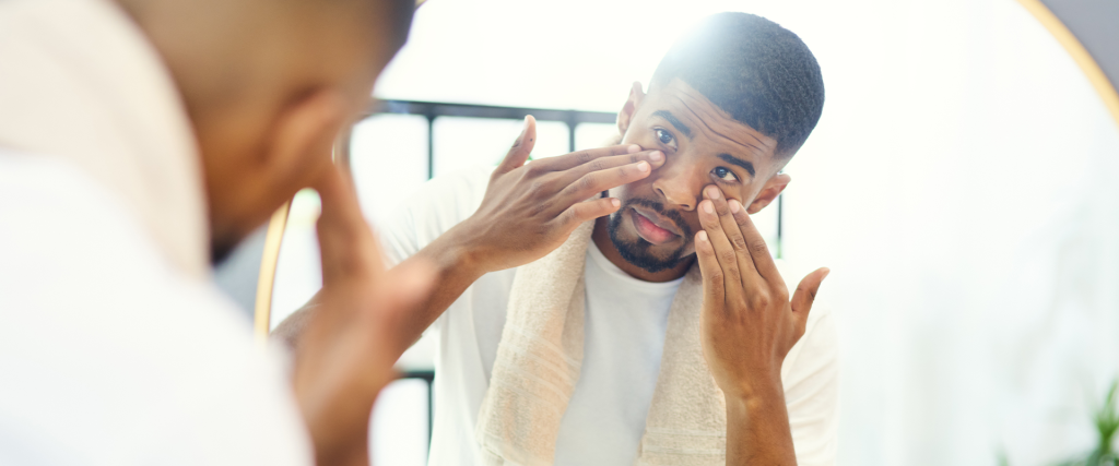 Man applying Moor House Grooming For Men anti-aging eye care in the mirror
