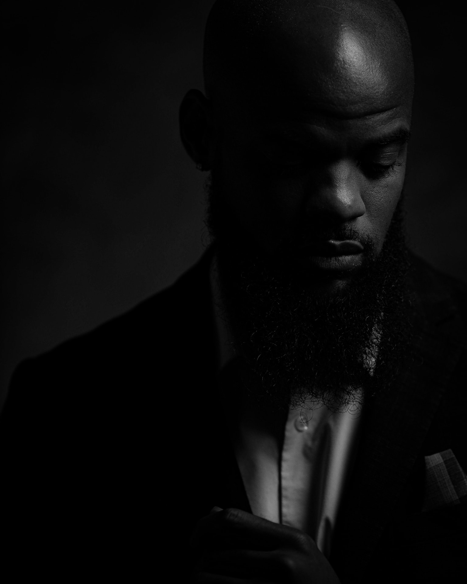 Man with a long beard in a dark portrait